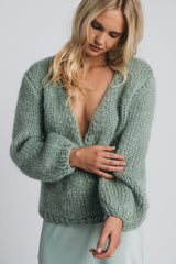 Huurre handknitted wrapknit in misty green. Model is wearing the knit and misty green kajo slipskirt. Hálo from north