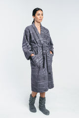 Kaarna bathrobe in grey worn by a model. Matched with grey wool socks. Hálo from north