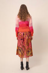 KAJO handknitted sweater in sunset worn with reidar sunset. Picture from behind. Hálo from north