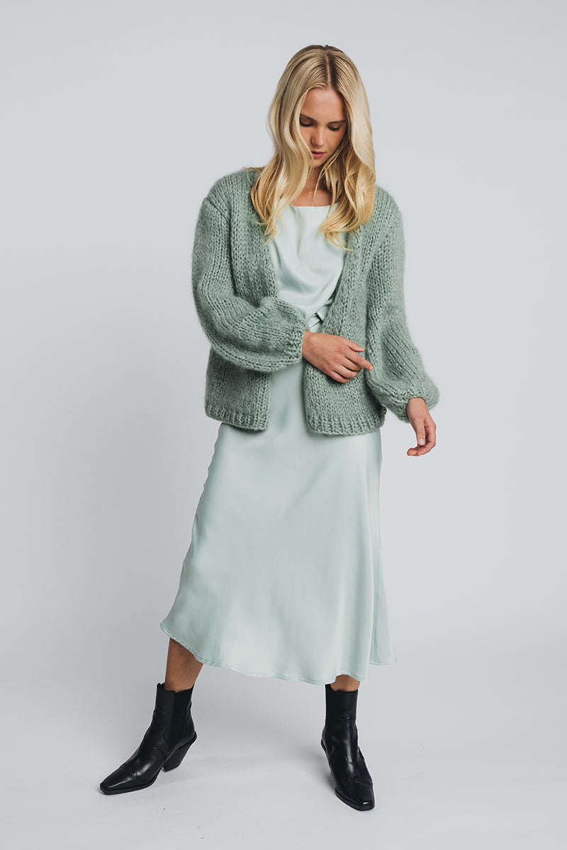 Kajo loose top in misty green worn with matching kajo slip skirt in misty green and huurre wrapknit in misty green. Hálo from north