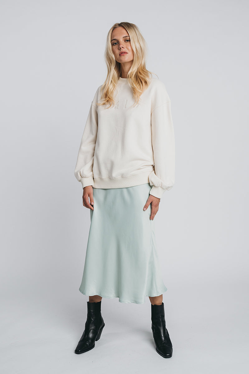 Neva woolen college in off white paired with kajo slip skirt. Front picture. Hálo from north