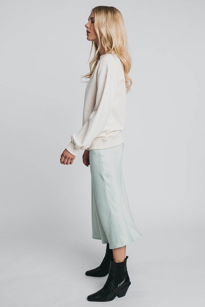 Neva woolen college in off white paired with kajo slip skirt in misty green. Side picture. Hálo from north