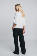 Tundra box shirt in white worn with kaarna wide pants. Picture from behind. Hálo from north